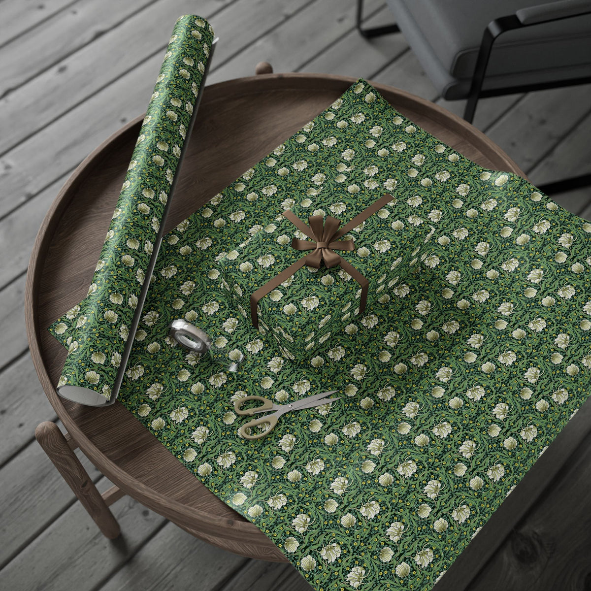 Green floral-patterned paper with scissors on a wooden tray
