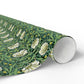 Roll of green floral patterned paper on a white background