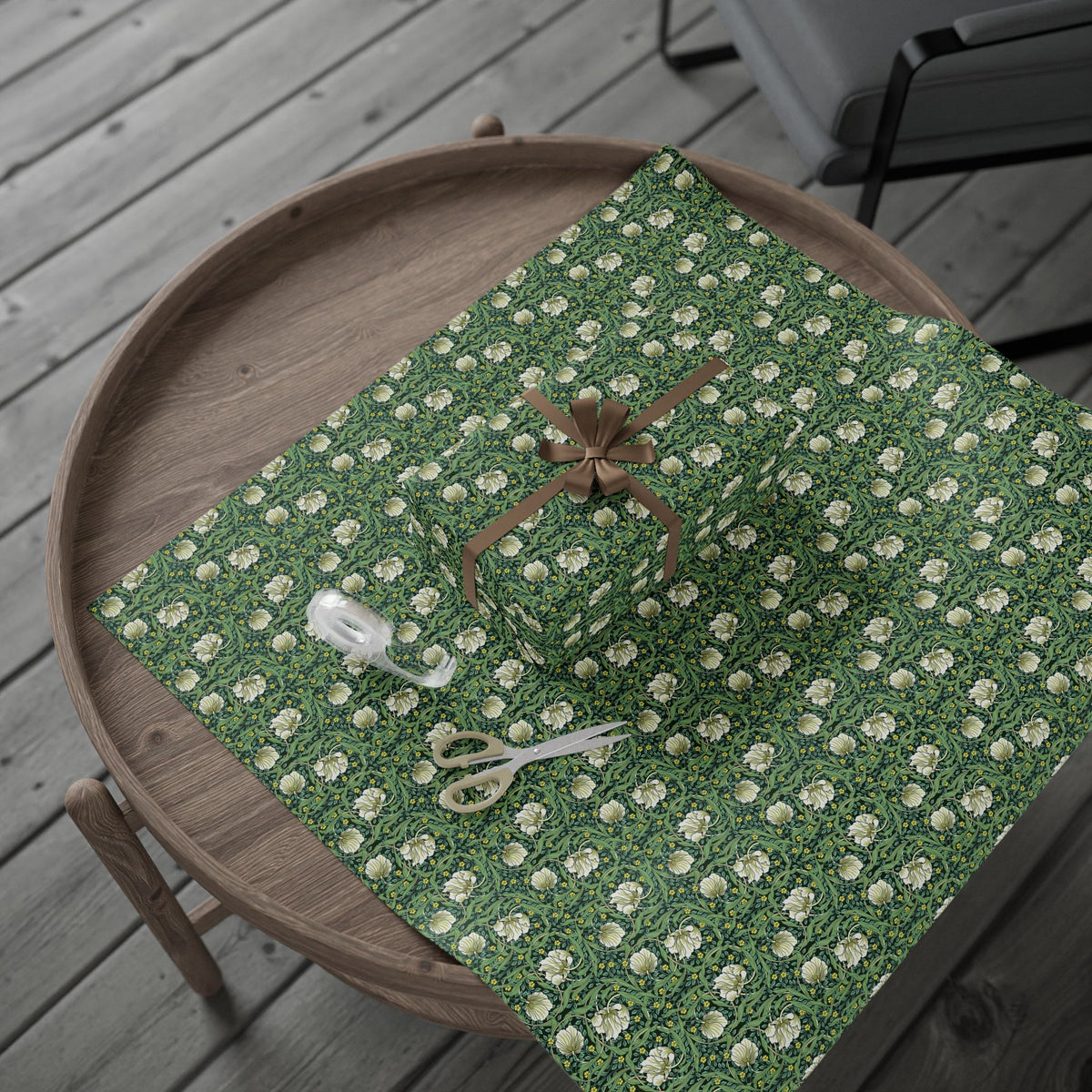 Green floral-patterned tablecloth on a wooden tray with a wooden chair in the background.