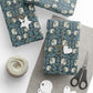 Gift wrap with floral pattern, scissors, and yarn on a white surface