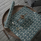 Decorative table runner with floral pattern on a wooden surface
