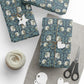 Gift wrap with floral pattern, star-shaped tag, heart-shaped tag, and scissors on a white surface.