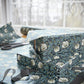 Gift wrapped in blue floral paper with scissors on a table