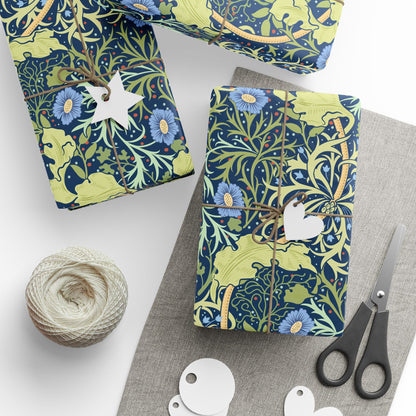 Gift-wrapped items with floral pattern, scissors, and yarn on a white surface