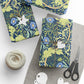 Gift-wrapped items with floral patterns, scissors, and twine on a white surface
