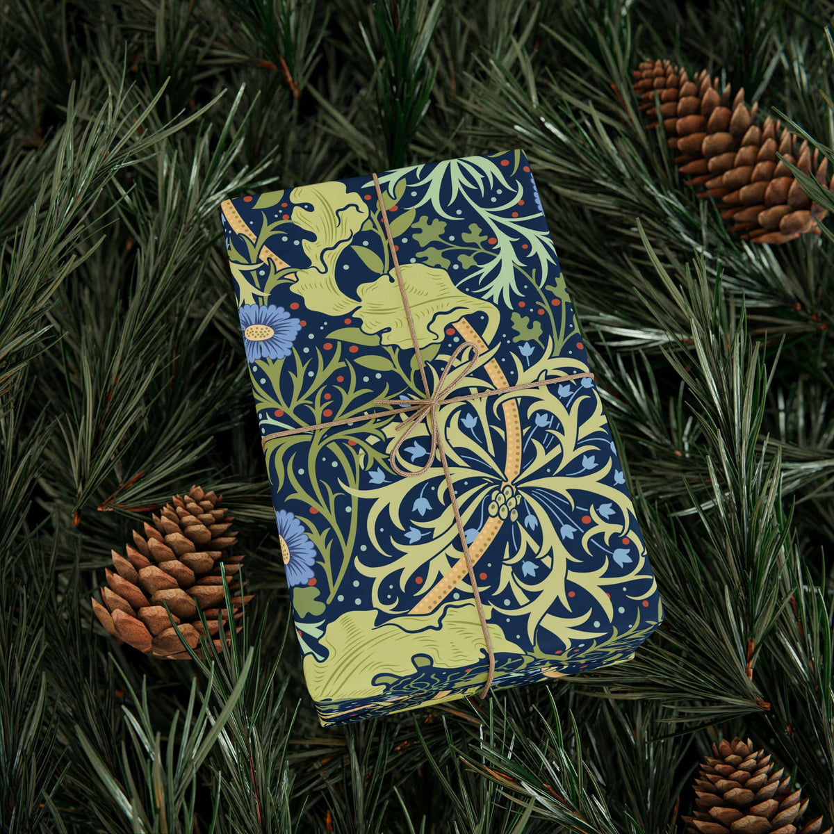 Decorative box with intricate patterns on a bed of pine needles and pine cones