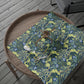 Decorative wrapping paper with floral pattern on a wooden tray