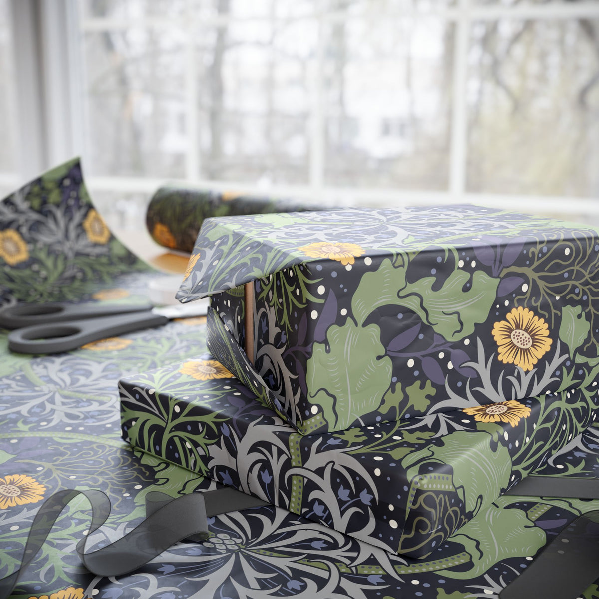 Gift boxes wrapped in floral-patterned paper with scissors on a table.