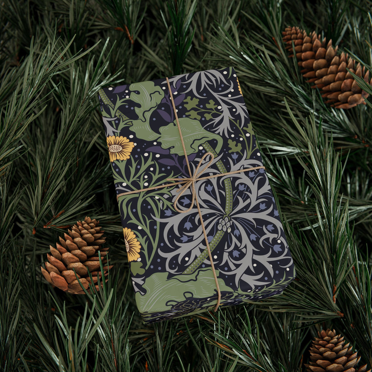 Decorative box with nature-themed design on a bed of pine needles and pine cones