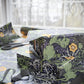 Gift wrapped in floral patterned paper with scissors on a table.
