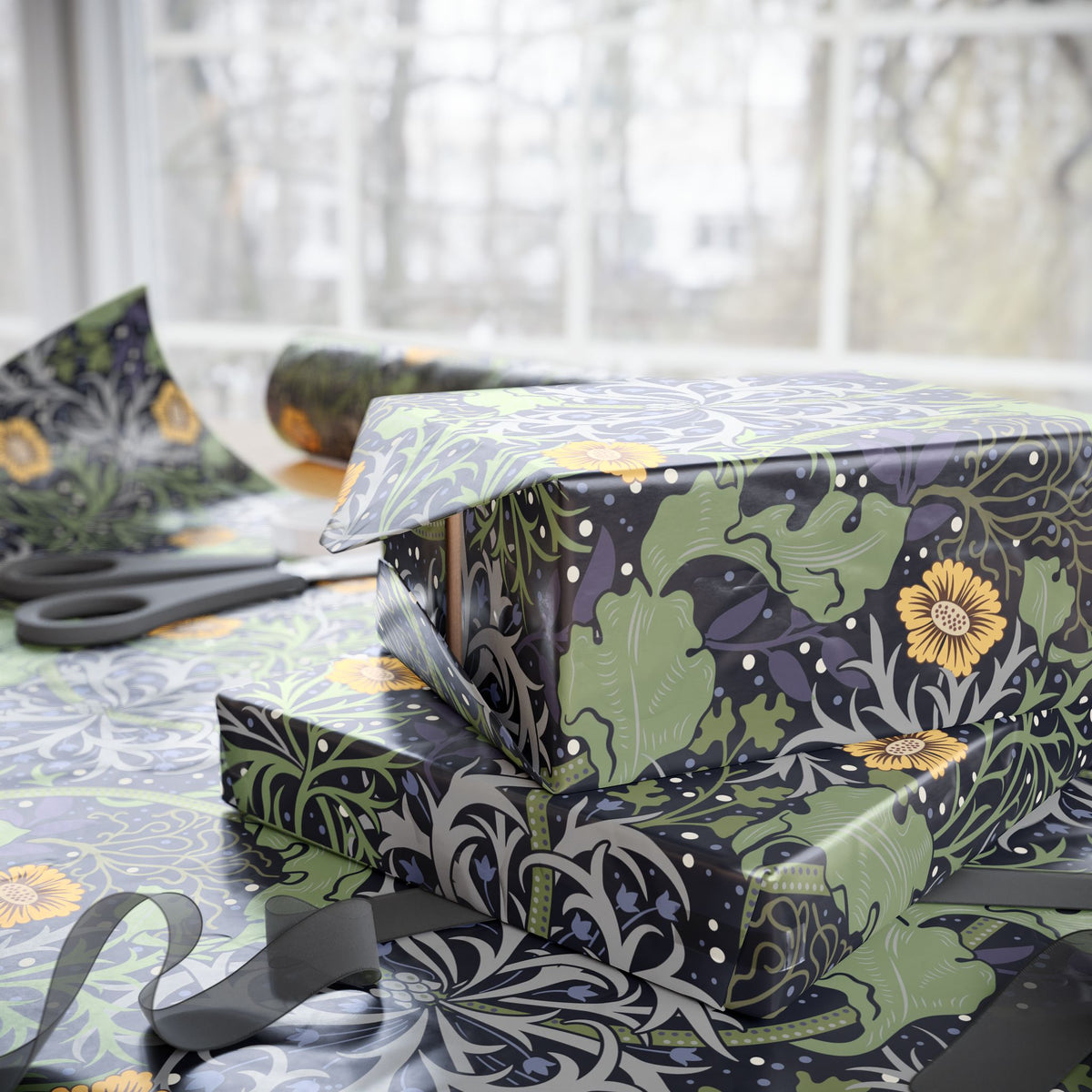 Gift wrapped in floral patterned paper with scissors on a table.