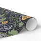 Roll of decorative paper with nature-themed design on a white background