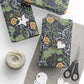 Gift-wrapped packages with floral patterns, scissors, and yarn on a white surface