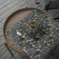 Floral-patterned wrapping paper with scissors on a wooden tray outdoors.