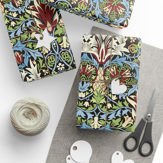 Colorful patterned gift boxes with a ball of yarn and scissors on a white surface