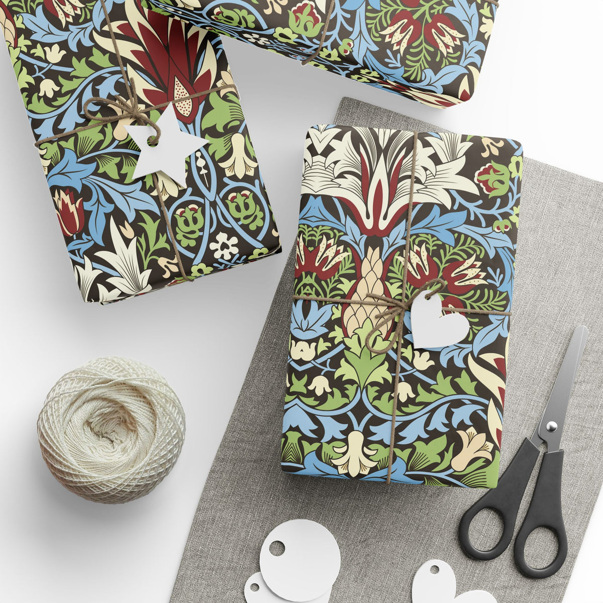 Colorful patterned fabric packages with scissors and yarn on a white background