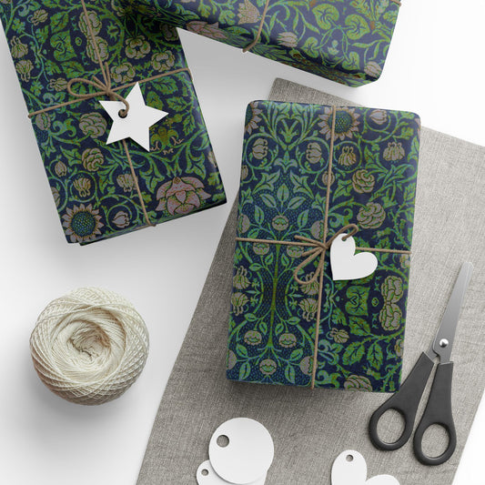 Gifts wrapped in green floral paper with decorative tags and scissors on a white surface