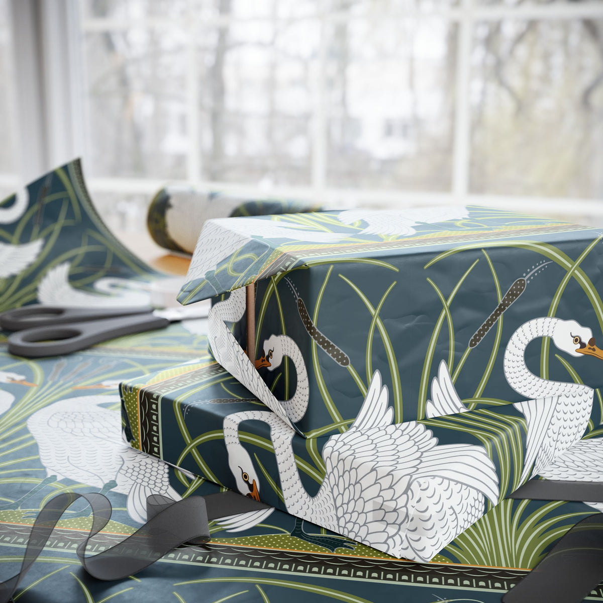 Gift wrapped in green paper with white swan design, scissors on a table.