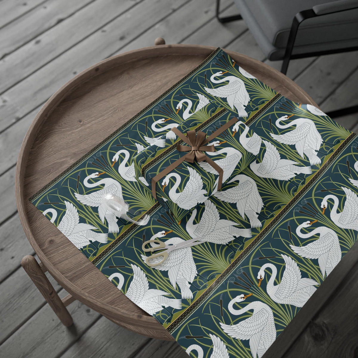 Decorative wapping paper with swan pattern on a wooden tray