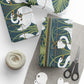 Gift-wrapped items with swan design, scissors, and yarn on a white surface