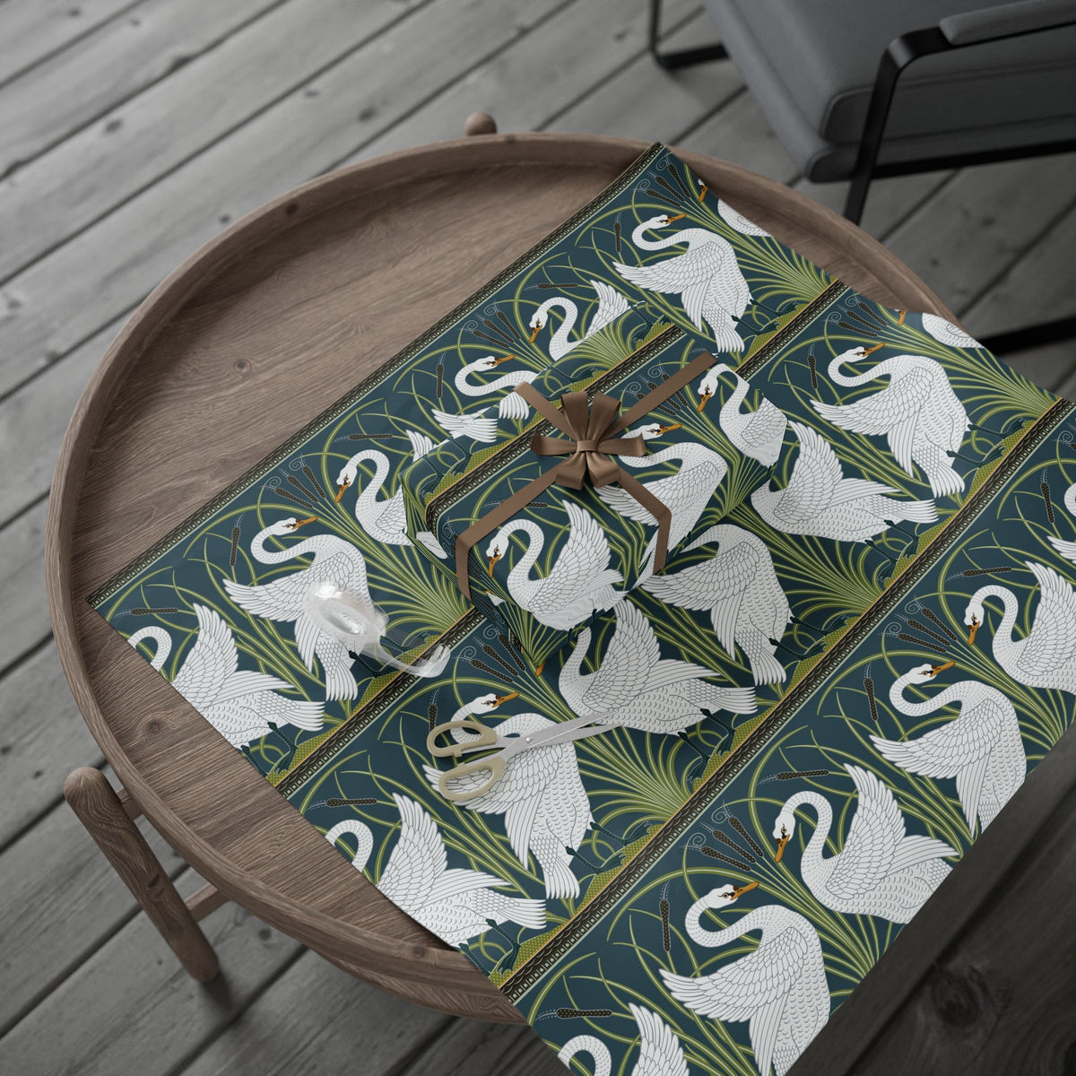 Decorative wrapping paper with swan pattern on a wooden tray
