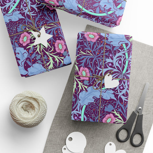 Gift-wrapped items with floral pattern, scissors, and yarn on a white surface
