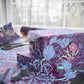 Stack of wrapped presents with floral pattern on a table