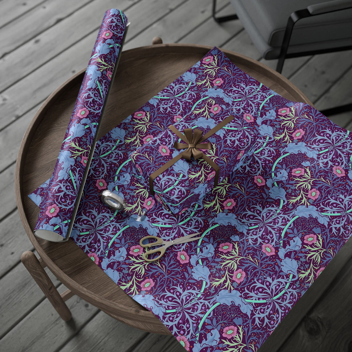 Floral-patterned fabric on a wooden table with scissors