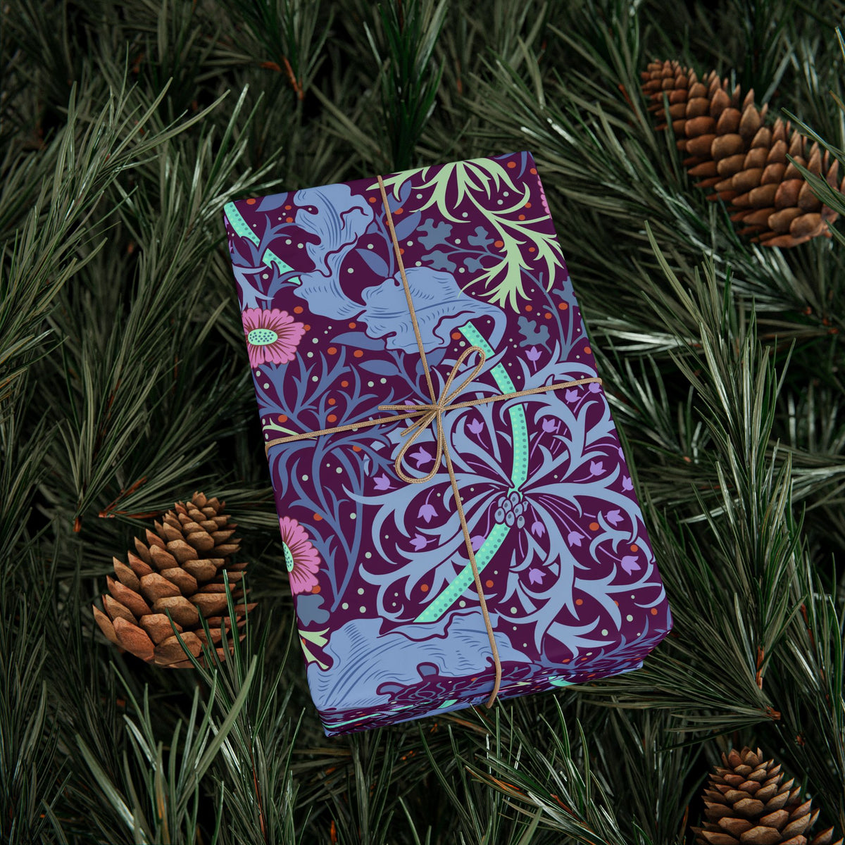 Purple patterned book tied with string on a green leafy background