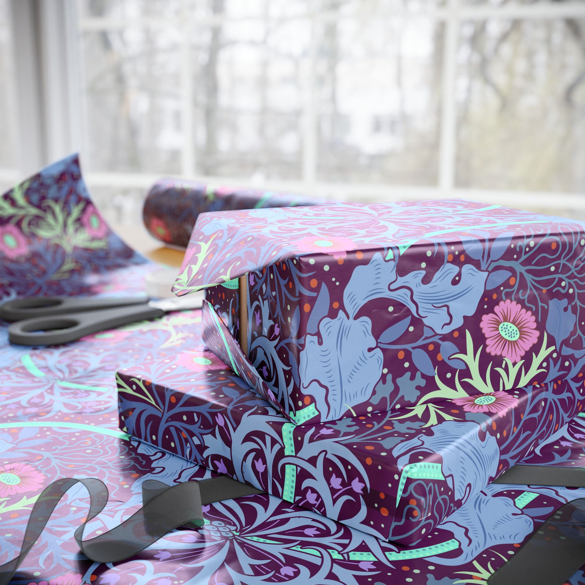 Gift boxes wrapped in colorful floral-patterned paper with ribbons on a table.