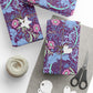 Gift-wrapped items with floral pattern, scissors, and yarn on a white surface