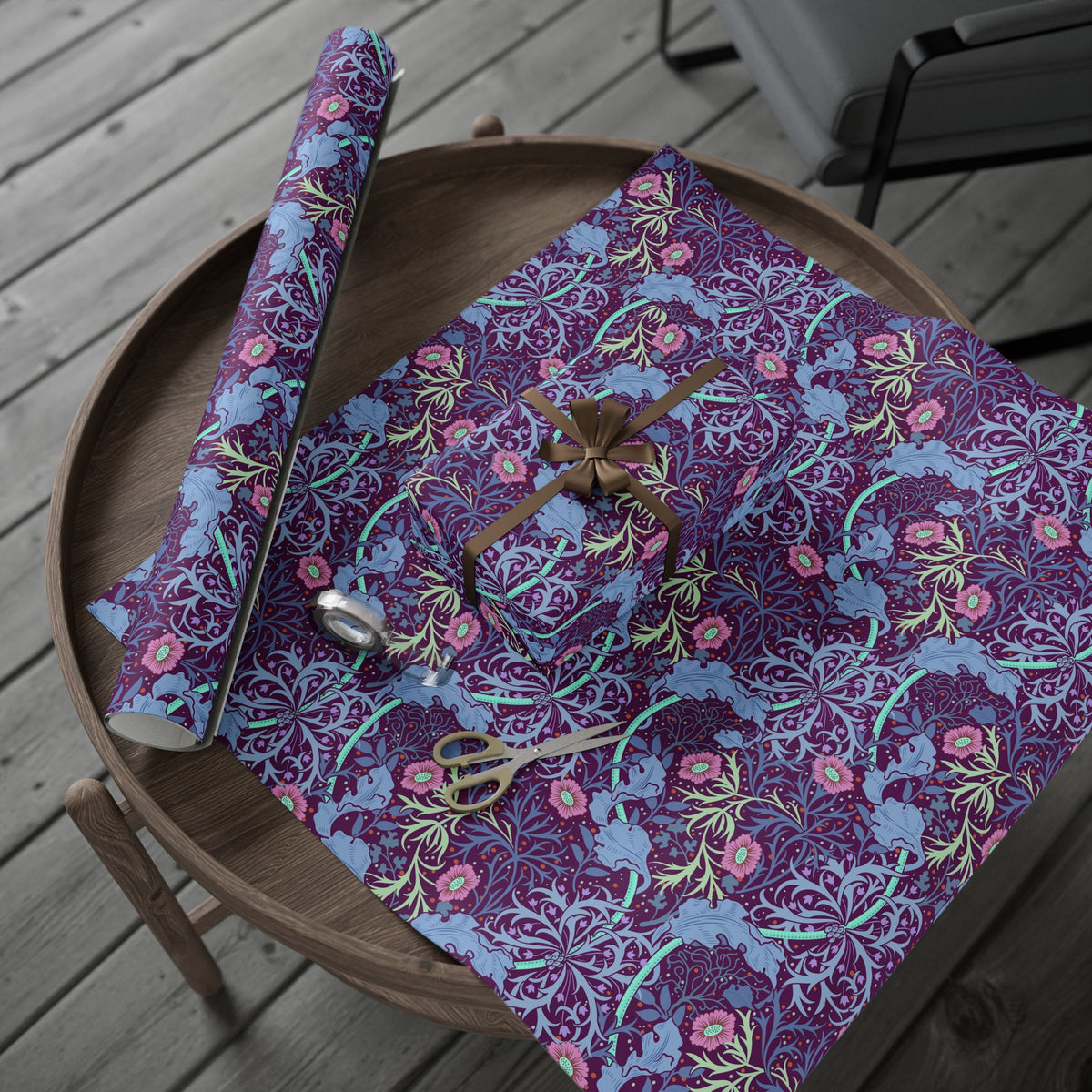 Floral-patterned fabric on a wooden table with scissors