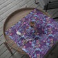 Floral-patterned wrapping paper n a wooden tray with cutlery
