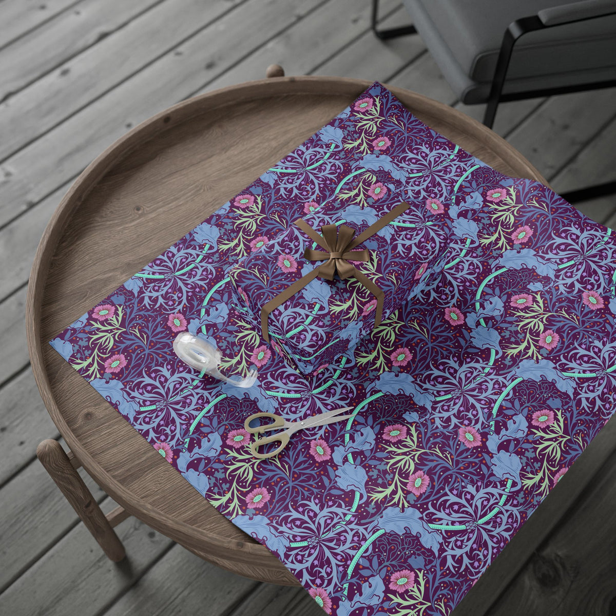 Floral-patterned fabric on a wooden tray with scissors on a wooden deck.