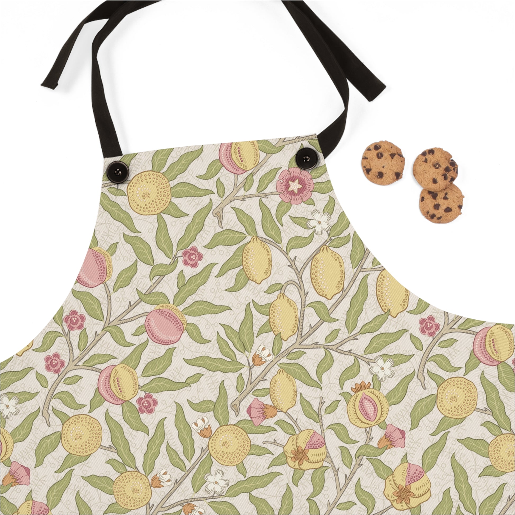 Floral and fruit patterned apron with cookies on a white background