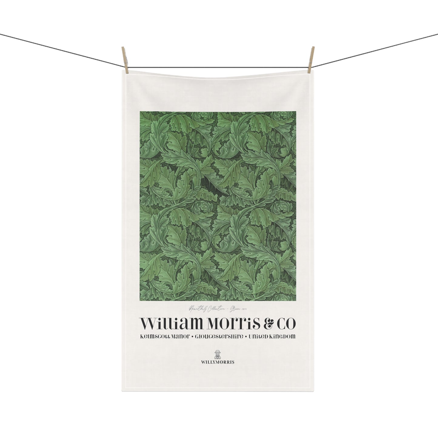 White towel with green leaf pattern and 'William Morris & Co' branding on a white background
