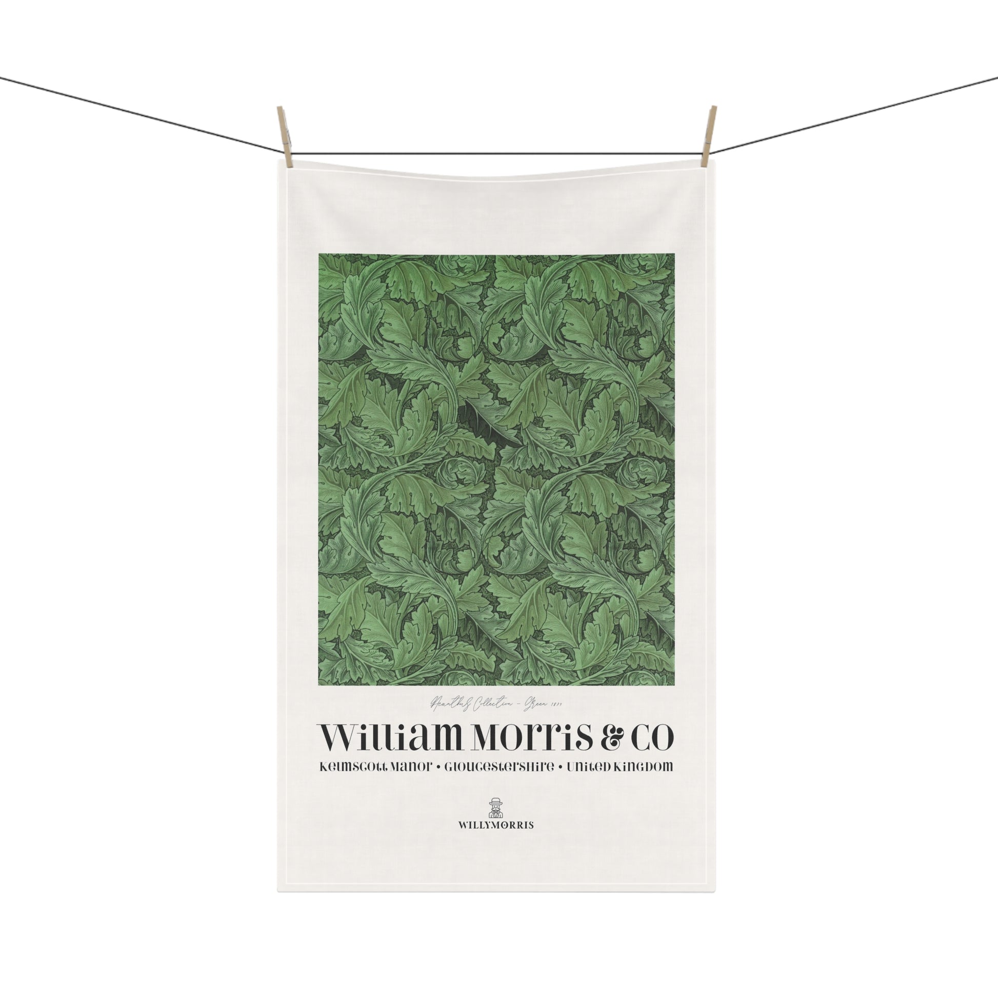 White towel with green leaf pattern and 'William Morris & Co' branding on a white background