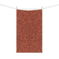 A kitchen tea towel with a floral and leaf William Morris & Co pattern, primarily in a brown and  colour.