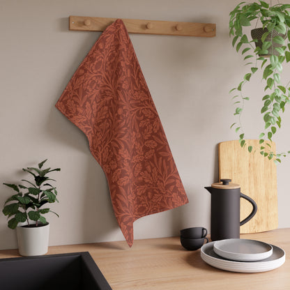 A kitchen tea towel with a floral and leaf William Morris & Co pattern, primarily in a brown and  colour.