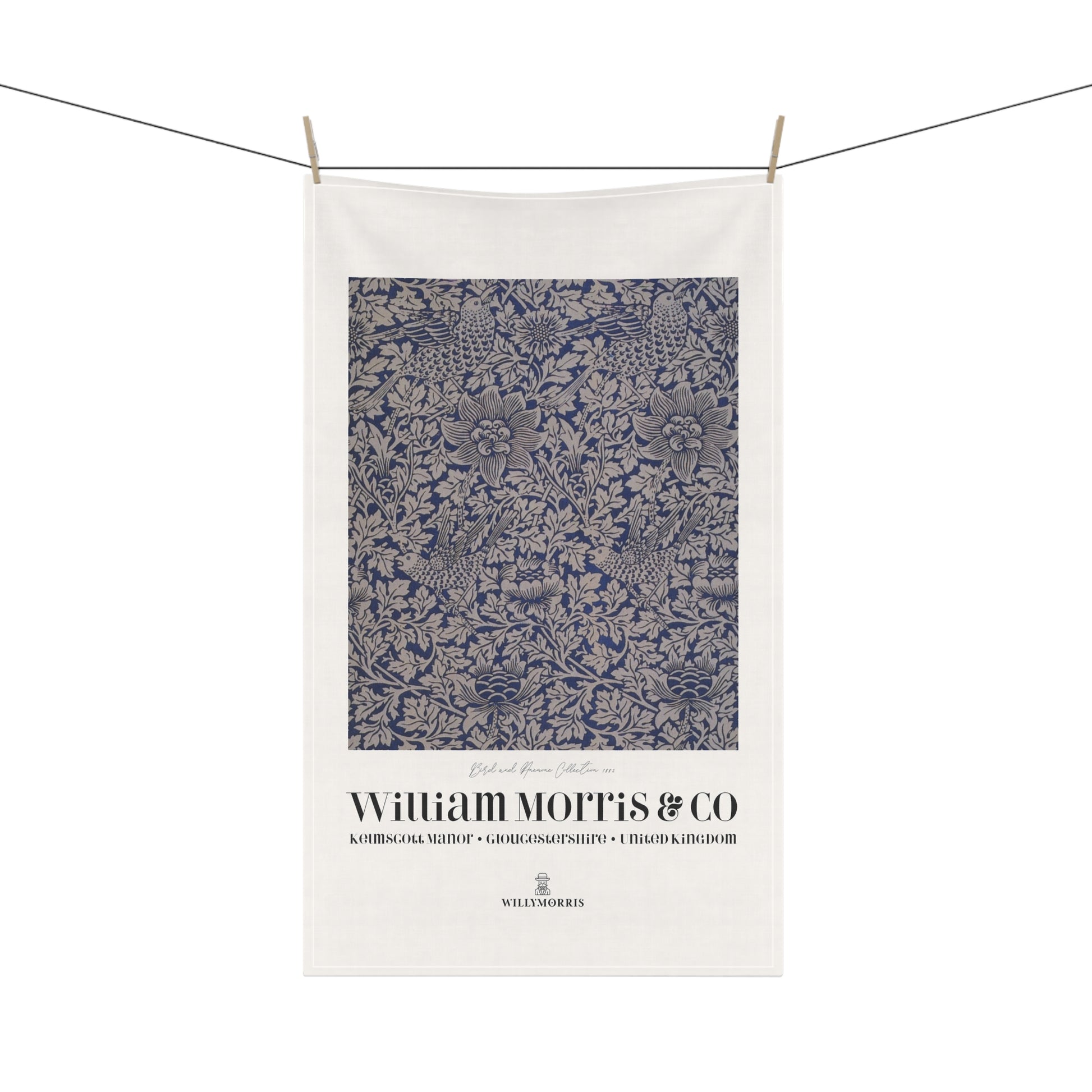 White towel with blue floral pattern and 'William Morris & Co' branding on a white background