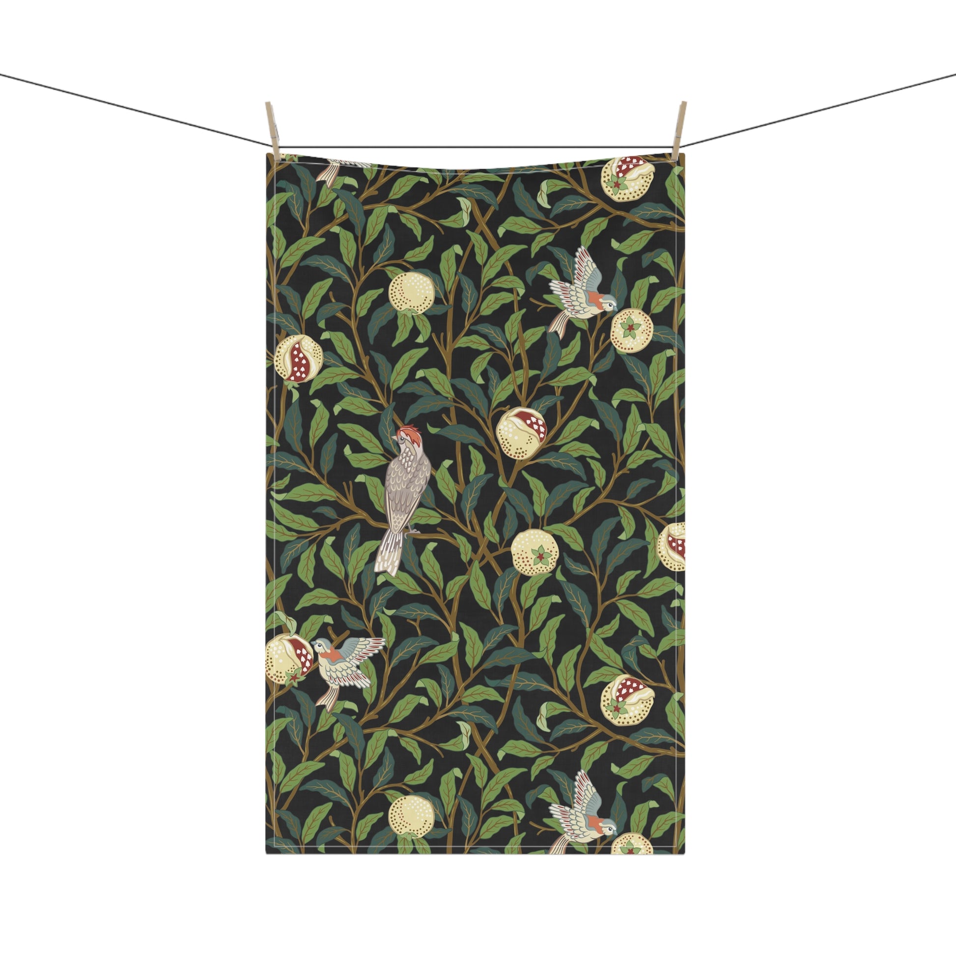 A kitchen tea towel with a design inspired by William Morris, featuring birds and pomegranate patterns on a dark background.