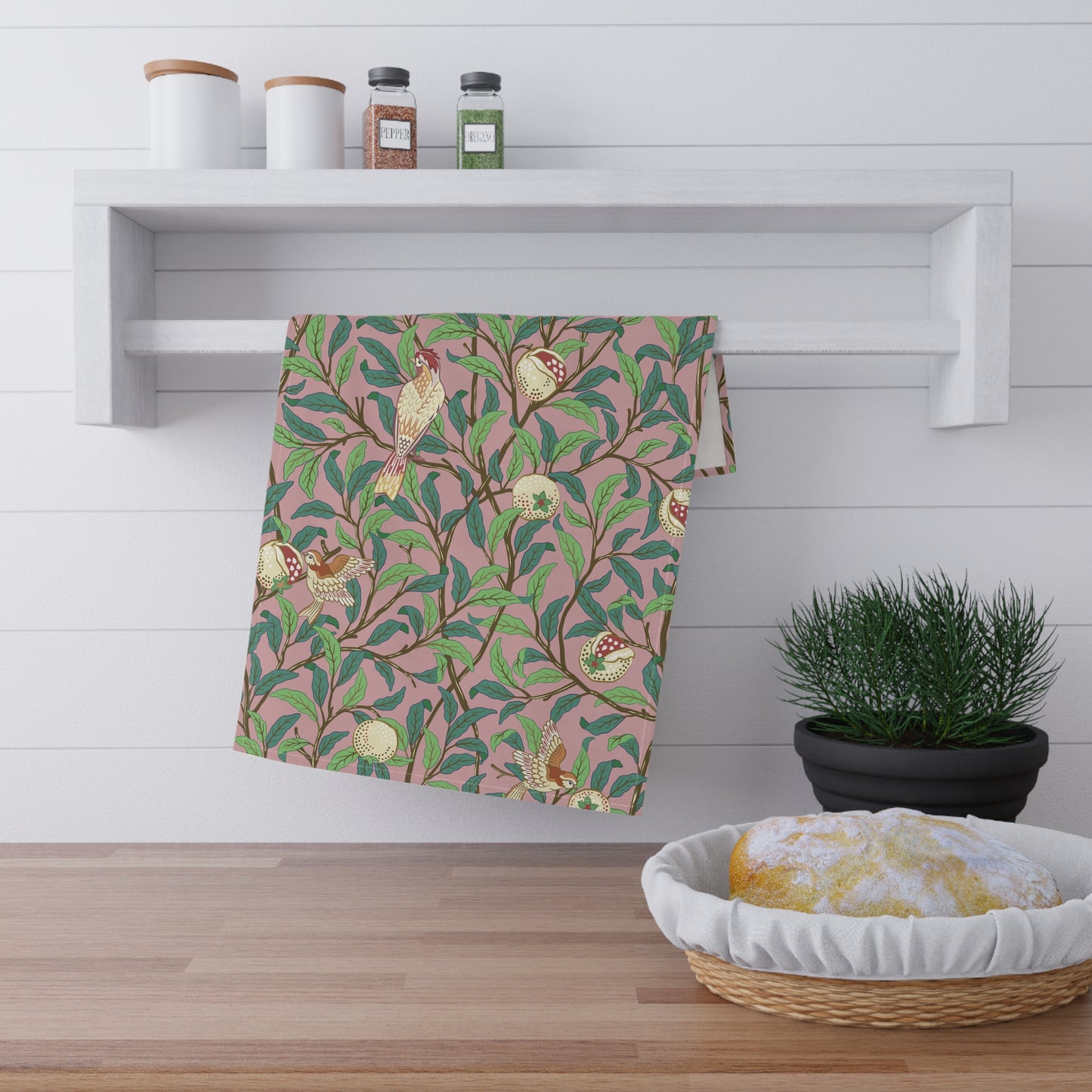 A kitchen tea towel with a floral and pomegranate design, inspired by the Art Nouveau style of William Morris.