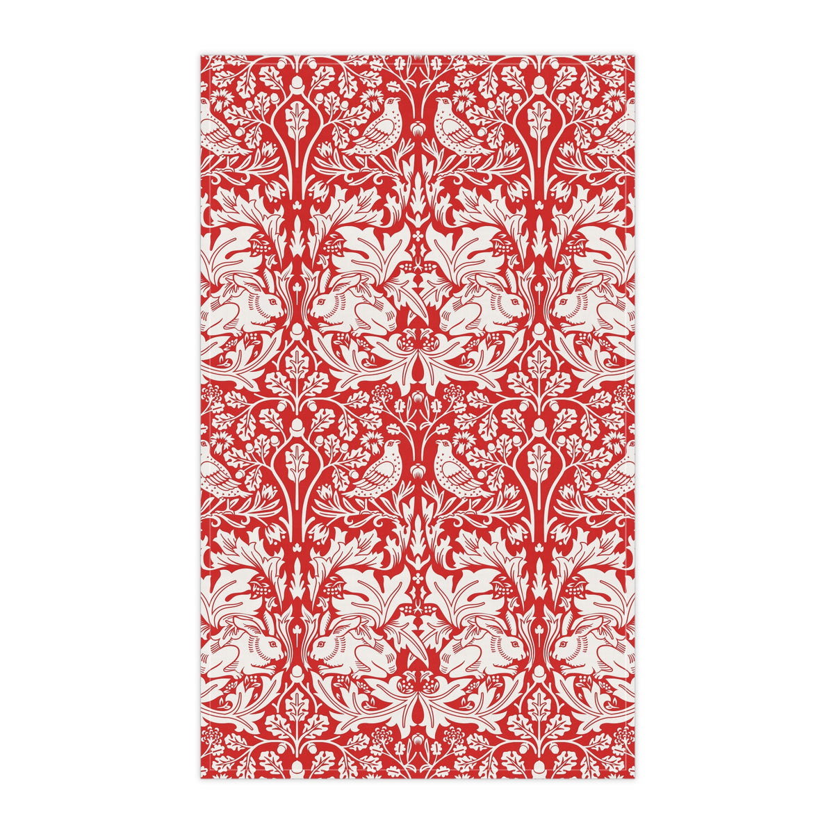 A rectangular tea towel featuring a classic red and white botanical pattern with stylised leaves and small birds, shown flat against a white background.