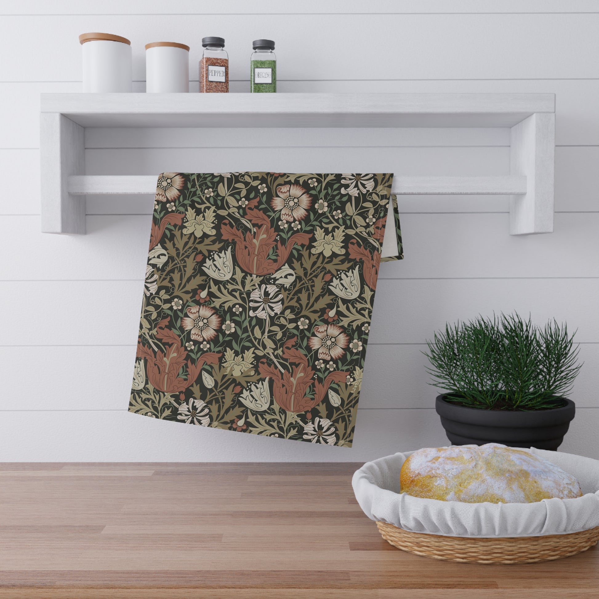 A rectangular kitchen tea towel featuring a floral pattern with brown and beige colours, inspired by William Morris & Co.