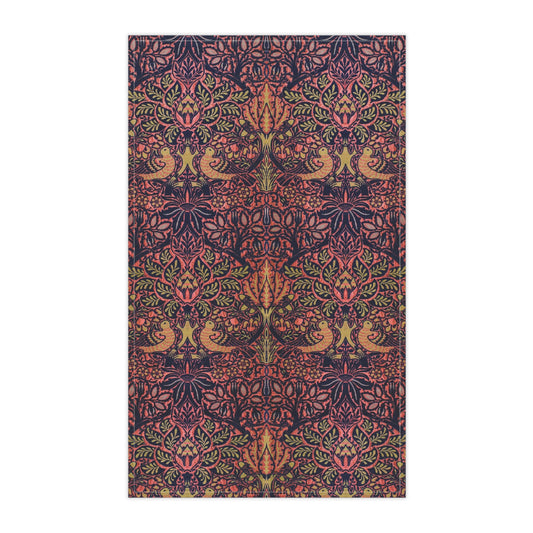 A kitchen tea towel with a floral and geometric pattern, predominantly in pink and purple colours.