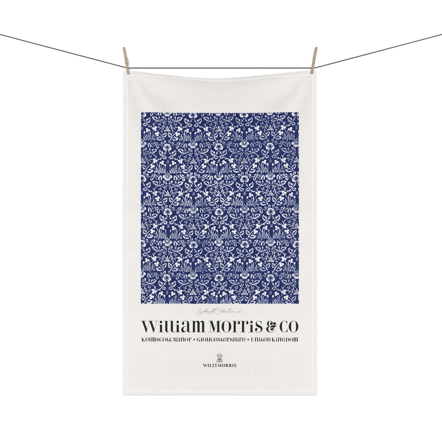 White towel with blue floral pattern and 'William Morris & Co' text on a white background