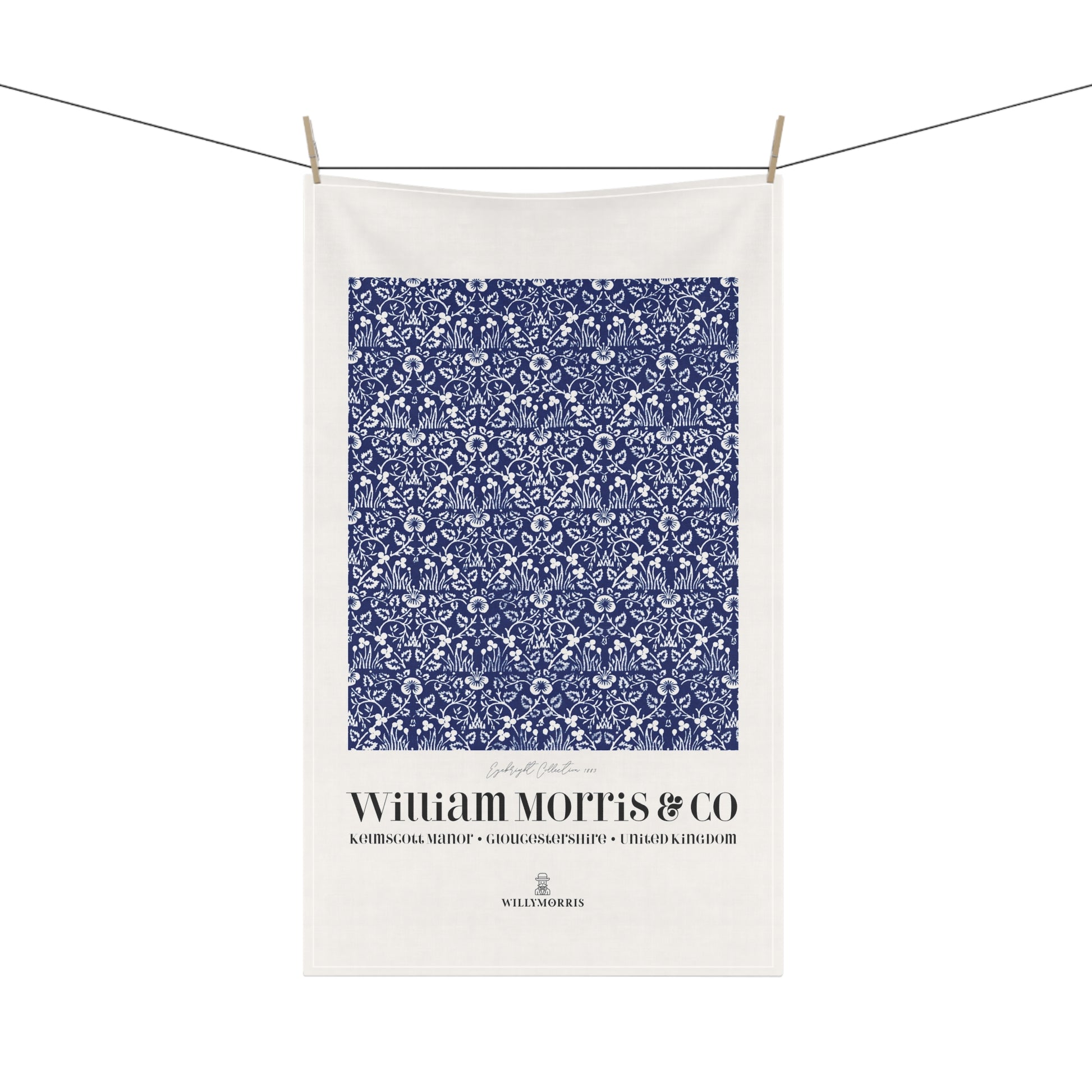 White towel with blue floral pattern and 'William Morris & Co' text on a white background