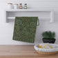 A kitchen tea towel with a floral garden pattern inspired by William Morris.