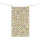 Tea towel with lemon and peach pattern hanging on a line