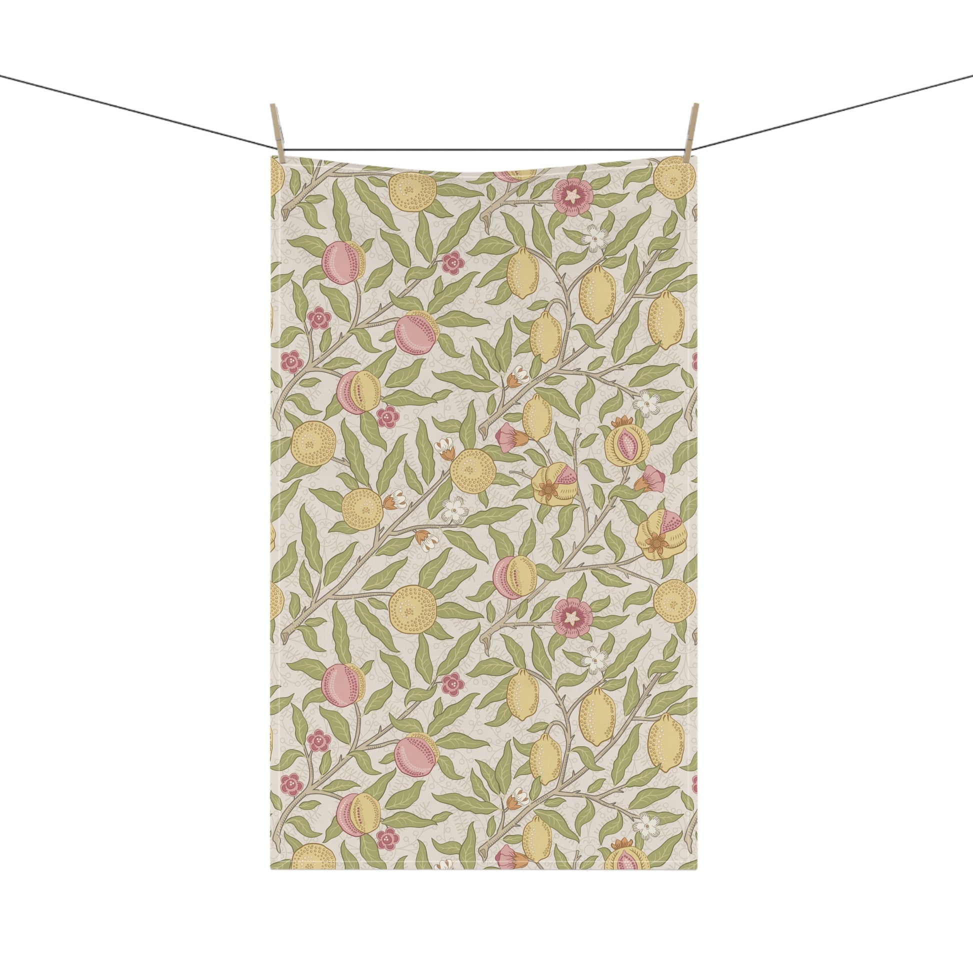 Tea towel with lemon and peach pattern hanging on a line
